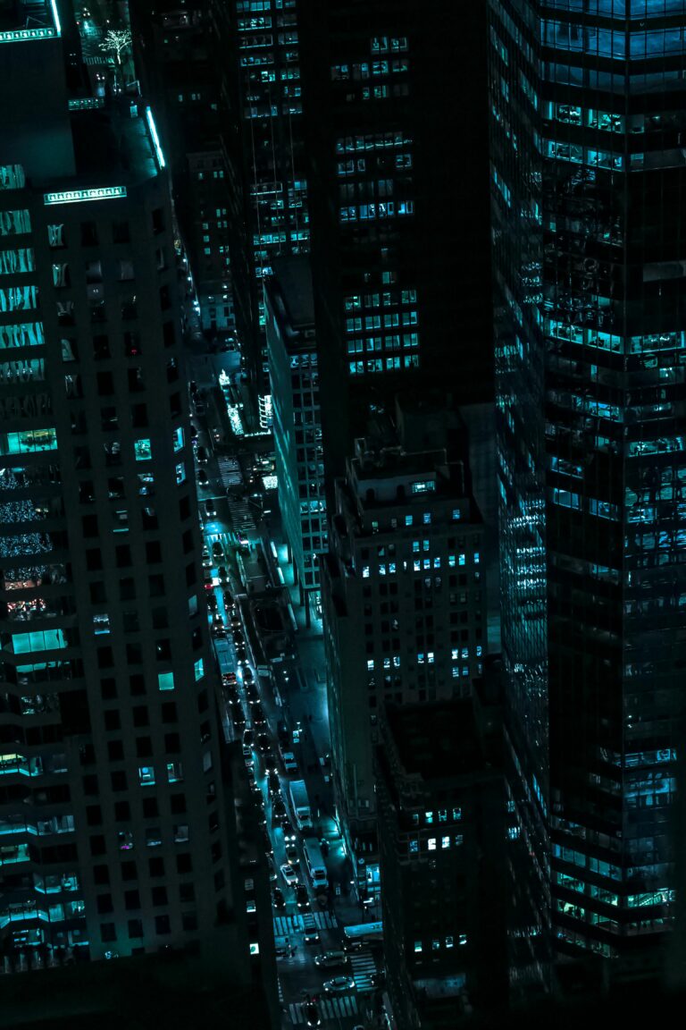 Captivating aerial view of illuminated skyscrapers in New York City during the night.